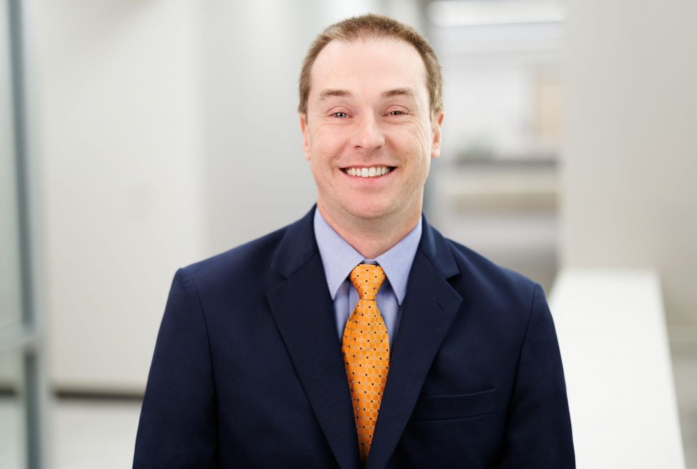 Dr. Jonathan Smith, medical director of Mercer Center for IDD Care, smiling in a suit.